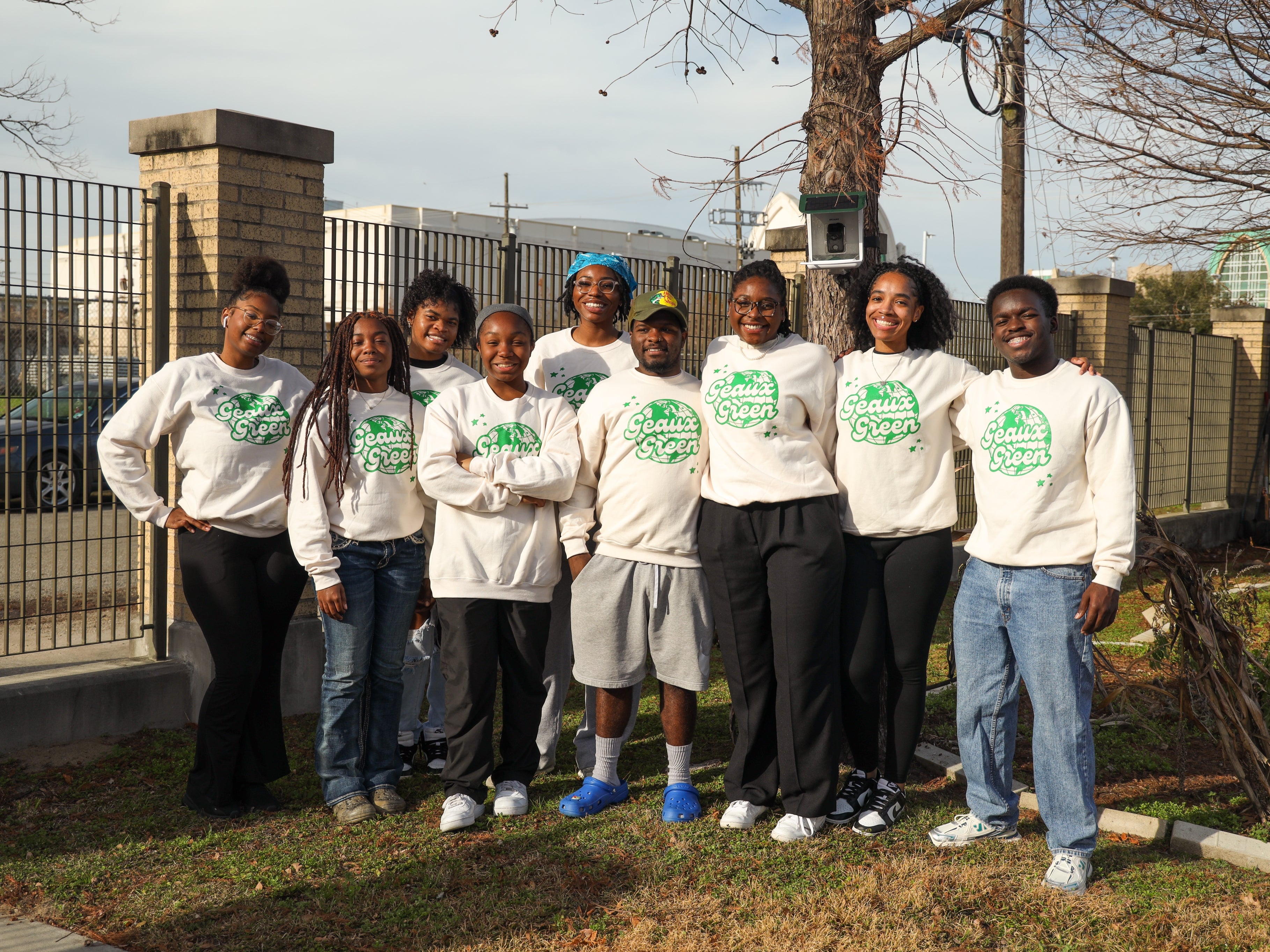 A group of students smile while outdoors 